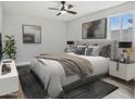Comfortable main bedroom with natural light, ceiling fan, and soothing wall art at 533 N Sirrine --, Mesa, AZ 85201