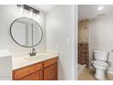 Bathroom featuring wood vanity, round mirror, modern lighting and tile shower with glass door at 533 W Guadalupe Rd # 1078, Mesa, AZ 85210