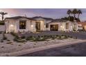 Attractive exterior showcasing desert landscaping, a glass garage door and a paved driveway at 7120 E Paradise Ranch Rd, Paradise Valley, AZ 85253