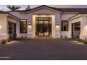 Beautiful front exterior with a paved driveway and a landscaped yard at 7120 E Paradise Ranch Rd, Paradise Valley, AZ 85253