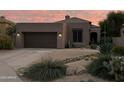 Charming single-story home with desert landscaping, a two-car garage, and a welcoming front entrance at 7169 E Bramble Berry Ln, Scottsdale, AZ 85266