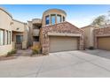 Beautiful two story home featuring a stone garage and a private drive at 7445 E Eagle Crest Dr # 1094, Mesa, AZ 85207