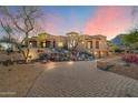 Beautiful home featuring a circular driveway and professionally landscaped yard at 9515 E Julep Cir, Mesa, AZ 85207