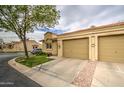 Single-story home with a two-car garage, manicured lawn, and paved driveway leading up to the entrance at 1021 S Greenfield Rd # 1142, Mesa, AZ 85206