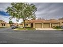 Attractive single-story home with two-car garage, neutral tones, red tile roof and green landscaping at 1021 S Greenfield Rd # 1142, Mesa, AZ 85206