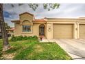 Inviting single-story home featuring a manicured lawn and a two-car garage at 1021 S Greenfield Rd # 1142, Mesa, AZ 85206