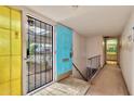 Bright blue front door entering into a home with retro architectural design elements at 1048 E 2Nd Pl, Mesa, AZ 85203