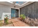 Covered front porch with a security door and a combination of brick and wood siding at 1048 E 2Nd Pl, Mesa, AZ 85203