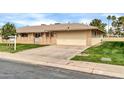 Single-story home with brick facade, attached garage, and well-maintained landscaping at 10646 W Tropicana Cir, Sun City, AZ 85351