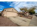 A charming home with a two-car garage and low-maintenance desert landscaping at 11330 W Eden Mckenzie Dr, Surprise, AZ 85378