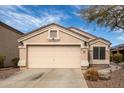 Charming one-story home featuring a two-car garage and low-maintenance desert landscaping at 11330 W Eden Mckenzie Dr, Surprise, AZ 85378