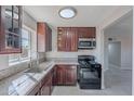 Bright kitchen features granite countertops, stainless steel appliances, and dark wood cabinets at 1137 E Mcmurray Blvd, Casa Grande, AZ 85122