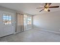 Cozy living room with tile floors, neutral paint, a ceiling fan, and natural light at 1137 E Mcmurray Blvd, Casa Grande, AZ 85122