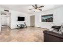 Bright living room with tile floors, a ceiling fan, and plenty of natural light at 11403 N 57Th Dr, Glendale, AZ 85304