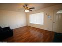 Bright living room featuring wood floors, a ceiling fan, and a window with natural light at 120 N 54Th St, Mesa, AZ 85205