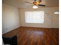 Bright living room featuring wood floors, a ceiling fan, and a window with natural light at 120 N 54Th St, Mesa, AZ 85205