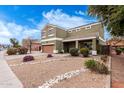 Charming two-story home boasts desert landscaping, rock accents and a covered porch at 12162 W Dreyfus Dr, El Mirage, AZ 85335