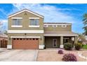 Inviting two-story home featuring low maintenance landscaping and a covered front porch at 12162 W Dreyfus Dr, El Mirage, AZ 85335