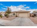 Single-story home featuring desert landscaping, tile roof, and a two-car garage at 12530 W Jackson St, Avondale, AZ 85323