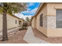 Exterior view of the side of the home and connecting walkway at 12530 W Jackson St, Avondale, AZ 85323