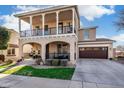 Inviting two-story home with a charming front porch and second story balcony at 13432 N 154Th Ln, Surprise, AZ 85379