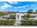 Well-maintained single story home with a landscaped front yard, a welcoming entrance, and mountain views at 13613 N 76Th St, Scottsdale, AZ 85260