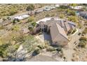 Aerial view of the desert home showcasing the barrel tile roof, desert landscaping, and circular driveway at 15241 E Pageland Cir, Fountain Hills, AZ 85268