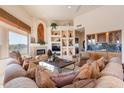 Spacious living room featuring a fireplace, built in wet bar, and large picture windows at 15241 E Pageland Cir, Fountain Hills, AZ 85268