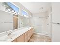 Bathroom featuring dual sinks, a large mirror, and glass-enclosed walk-in shower at 15525 W Clear Canyon Dr, Surprise, AZ 85374