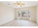 Bright bedroom with large windows offering a view of the landscaped yard at 15525 W Clear Canyon Dr, Surprise, AZ 85374