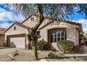 Beautiful single-story home with low-maintenance desert landscaping and an attached two-car garage at 16172 W Starlight Dr, Surprise, AZ 85374