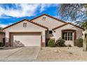 Charming single-story home featuring a well-maintained front yard and a spacious two-car garage at 16172 W Starlight Dr, Surprise, AZ 85374