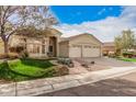 Well-maintained single-story home with lush green lawn, desert landscaping, and two-car garage on a sunny day at 16811 S 11Th Way, Phoenix, AZ 85048