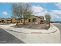 Well-maintained home showcasing desert-friendly landscaping and a convenient corner lot at 17555 W Glenhaven Dr, Goodyear, AZ 85338