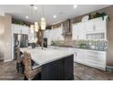 Bright kitchen features a large island with a white countertop and unique backsplash at 20551 E Mayberry Rd, Queen Creek, AZ 85142