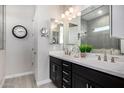 Modern bathroom with double vanity, dark cabinets, and a sleek design, offering a luxurious experience at 21413 N 59Th St, Phoenix, AZ 85054