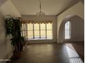 Dining room featuring tiled floors, a large window, and a decorative light fixture at 26637 S New Town Dr, Sun Lakes, AZ 85248