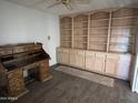 A home office featuring a built-in bookshelf and storage cabinet, along with an antique wooden desk at 26637 S New Town Dr, Sun Lakes, AZ 85248