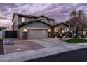 Beautiful home featuring an attached garage, a basketball hoop, and manicured landscaping at 3274 E Isaiah Ct, Gilbert, AZ 85298