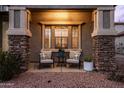 Relaxing front porch area with comfortable seating and decorative stone pillars at 3274 E Isaiah Ct, Gilbert, AZ 85298