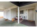 Welcoming covered patio with comfortable seating area near entry at 4022 W Kaler Dr, Phoenix, AZ 85051