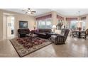 Spacious living room featuring tile floors, a ceiling fan, and views of the dining area at 4221 E Sourwood Dr, Gilbert, AZ 85298