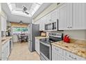 Bright kitchen featuring stainless steel appliances, white cabinets and adjacent dining area at 4510 E Emelita Ave, Mesa, AZ 85206