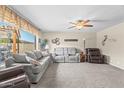 Spacious living room featuring a large window, neutral tones, and comfortable seating at 4510 E Emelita Ave, Mesa, AZ 85206