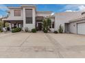 Stunning desert home featuring a spacious driveway, lush landscaping, and a modern stucco exterior at 4822 S Gold Canyon Dr, Gold Canyon, AZ 85118