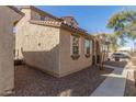 Side view of a charming stucco home with a red tile roof and desert landscaping at 5474 W Fulton St, Phoenix, AZ 85043