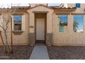 Charming stucco home featuring a beautiful arched entry and desert landscaping at 5474 W Fulton St, Phoenix, AZ 85043