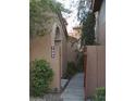 Charming walkway leading to the entrance of the home, lined with desert landscaping at 5640 E Bell Rd # 1081, Scottsdale, AZ 85254