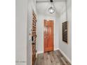 Welcoming entryway with wood-look floors, features a decorative light fixture and stylish interior doors at 5951 E Inglewood St, Mesa, AZ 85205