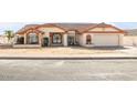 Lovely home with a tile roof, large front windows, and a two-car garage, ideal for comfortable living at 5951 E Inglewood St, Mesa, AZ 85205